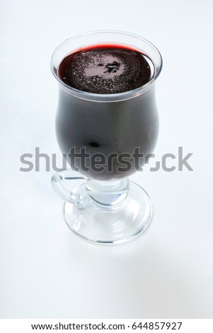 Hot mulled wine with spices, apple and orange on white background. Isolated