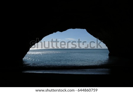 Sea landscape in Portugal view from inside a dark cave