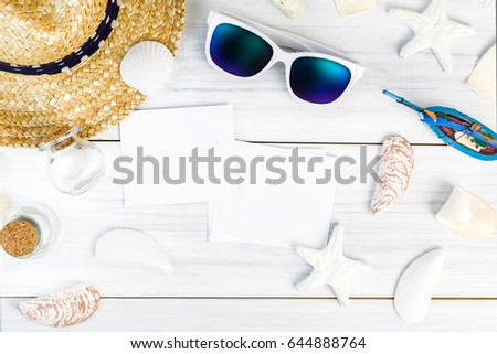 Summer Beach accessories (White sunglasses,starfish,straw hat,shell) and photo frame on white plaster wood table top view,Summer vacation concept,Leave space for adding your photo.