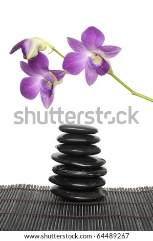 branch orchid with stack stones on bamboo stick straw mat