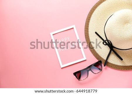 woman hat and happy holiday text in White picture frame and sunglasses on pink background ,copy space,flat lay