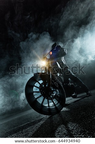 High power motorcycle chopper at night. Smoke on background. Royalty-Free Stock Photo #644934940