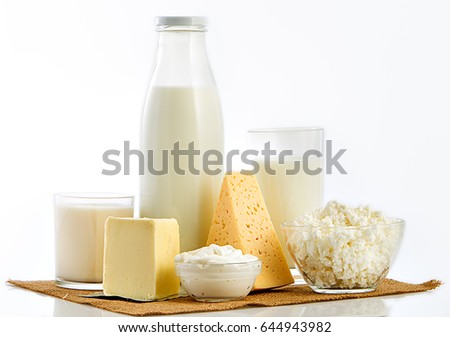 Bottle of milk, glass and cheese over white background.