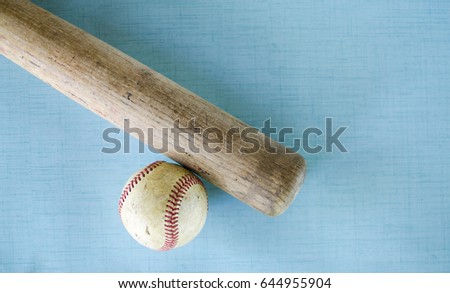 Background or graphic for baseball activity, showing vintage ball bat and old hardball on blue texture. Great for player, coach or team image.