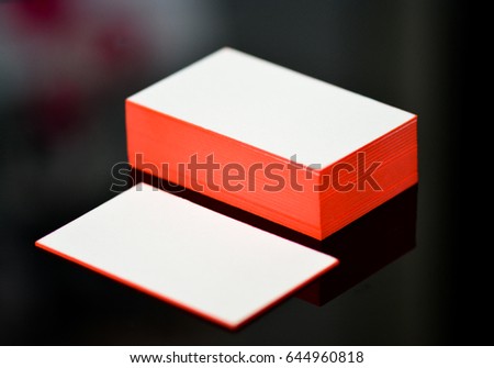thick white cotton paper business card mock up with red painted edges. Blank business cards template.
