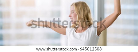 Young attractive woman at modern office desk, with laptop, stretching. Business concept illustration. Horizontal photo banner for website header design with copy space for text 