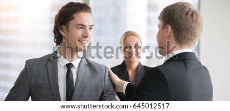 Boss promoting male subordinate. Two businessmen handshaking, congratulating on promotion, getting higher pay rate, financial bonus. Horizontal photo banner for website header design 