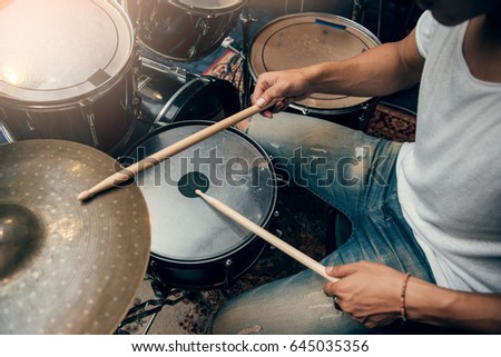Drummer plays drum in studio Royalty-Free Stock Photo #645035356