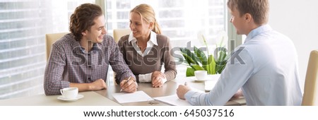 Young couple in love starting family life, applying for mortgage to buy accommodation, purchasing, renting apartment, meeting with real estate agent. Horizontal photo banner for website header design 