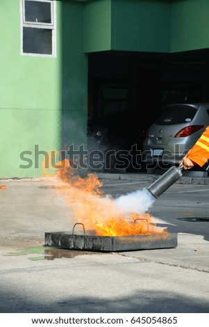 Firefighter demonstrating how to use a fire extinguisher
