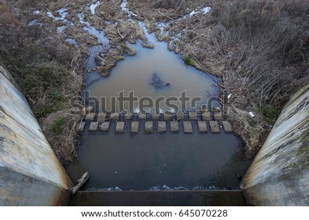Muddy water outlet and damn