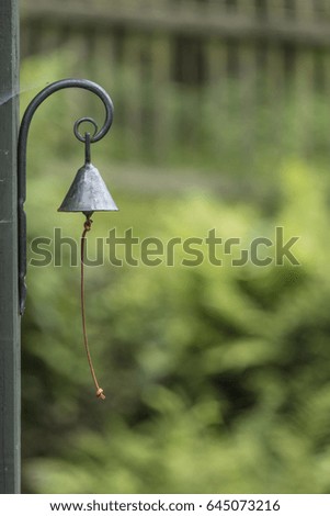 Single garden bell with blurred background.