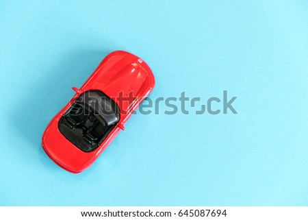 Retro toy car detail. Red car with an open top on a white background
