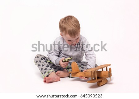 Cute toddler with dermatitis with plane on white backgoround