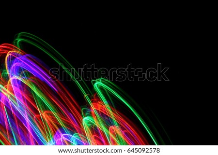 Multi-colour light painting photography, red, green and blue against a black background
