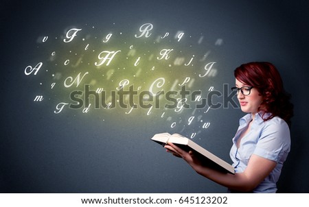 Casual young woman holding book with shiny letters flying out of it