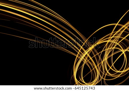 Gold Light Painting Photography, against a black background