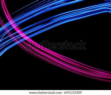 Blue and Pink Light Painting Photography, smooth curves cross shape against a black background