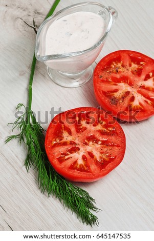 Tomato, sauce, dill on a wooden board on a rustic table. Country style. Cold appetizer. Easy snack. Healthy food. Vegetarian. Vegetables, seasonings, spices
