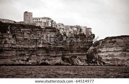 sepia picture of Bonifacio city in Corsica island as seen from the sea, France