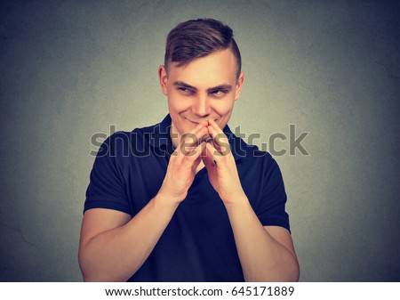 Sneaky man plotting something isolated on gray wall background. Negative human emotion facial expression feeling attitude Royalty-Free Stock Photo #645171889