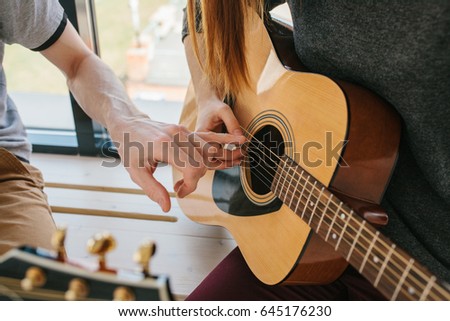 Learning to play the guitar. Music education and extracurricular lessons.