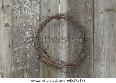 Roll Of Barb Wire Hanging On Old Fence