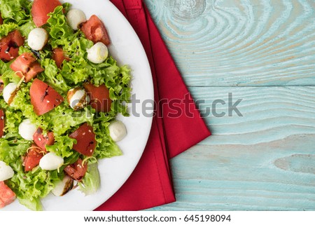 Fresh salad with tomato and mozzarella, healthy food concept.