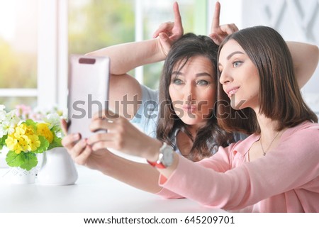 Mom with daughter with a tablet 