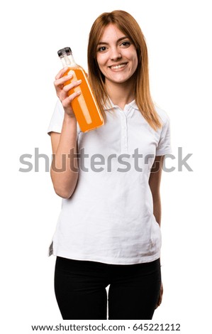 Happy Beautiful young girl holding an orange juice