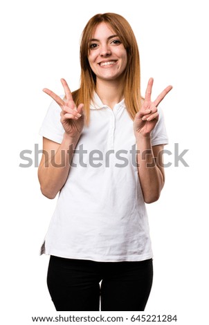 Beautiful young girl making victory gesture