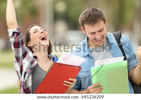 Two excited students with approved exams in the street Royalty-Free Stock Photo #645236209