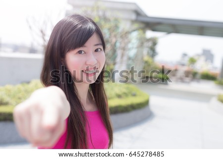 woman smile happily  pointing to you 