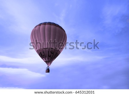Colorful hot air balloon on blue sky.