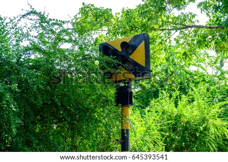 Old lamp pole (signal light) in railway station, tree cover traffic lights, Thailand local