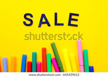 Art - Sale - wooden letters with colored pens on yellow background

