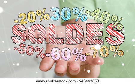 Businessman on blurred background holding sales icons in his hand 3D rendering ("soldes" means sales in french)