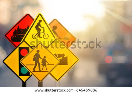 Set of traffic warning sign on blur traffic road with colorful bokeh light abstract background. Copy space of transportation and travel concept. Retro tone filter effect color style.