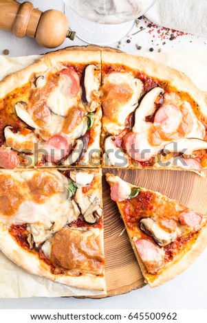 Pizza closeup on wooden board top view
