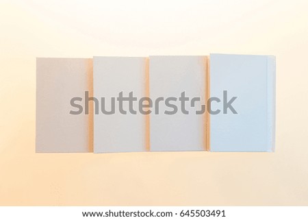 Blank clean white book on a light colorful gradient background
