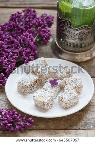 Turkish delight on a plate and mint tea / selective focus 