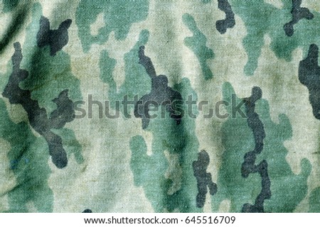 Weathered camouflage uniform pattern. Abstract background and texture for design.