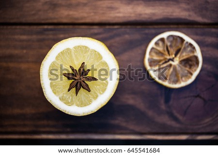 A slice of fresh lemon along with a slice of dry pier. Young and old. Beautiful and old. Concept of healthy life. Toned with old fashioned colors.