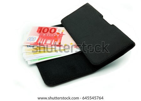 banknotes in a wallet on a white background