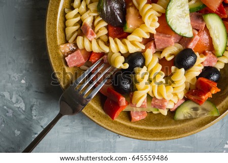 Fresh homemade pasta salad with tomatoes, olive and pepper. Shallow depth of field.