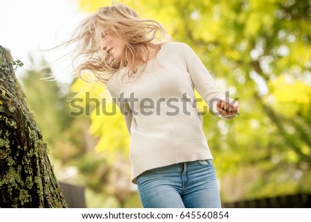 outdoor portrait of young happy smiling woman on natural background