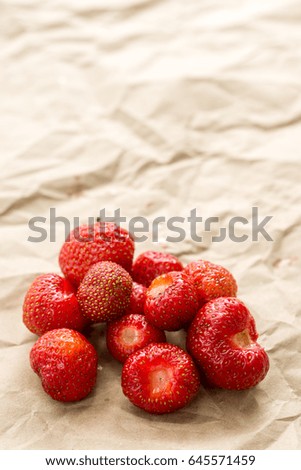 Fresh strawberries from the garden on the brown paper.