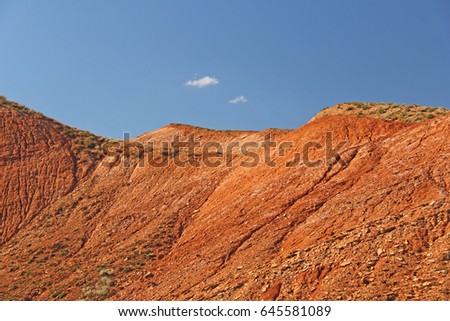 Beautiful mountains of red clay against the blue sky. Landscape of the desert. Space for text. dramatic landscape of the clay desert.