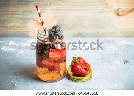 Fresh cocktail with strawberry and basil in glass. Shallow depth of field.