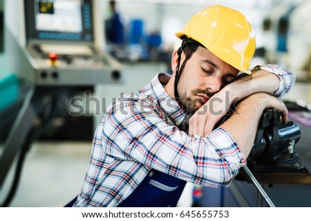 Tired worker fall asleep during working hours in factory Royalty-Free Stock Photo #645655753
